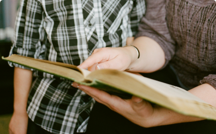 Two people reading a book